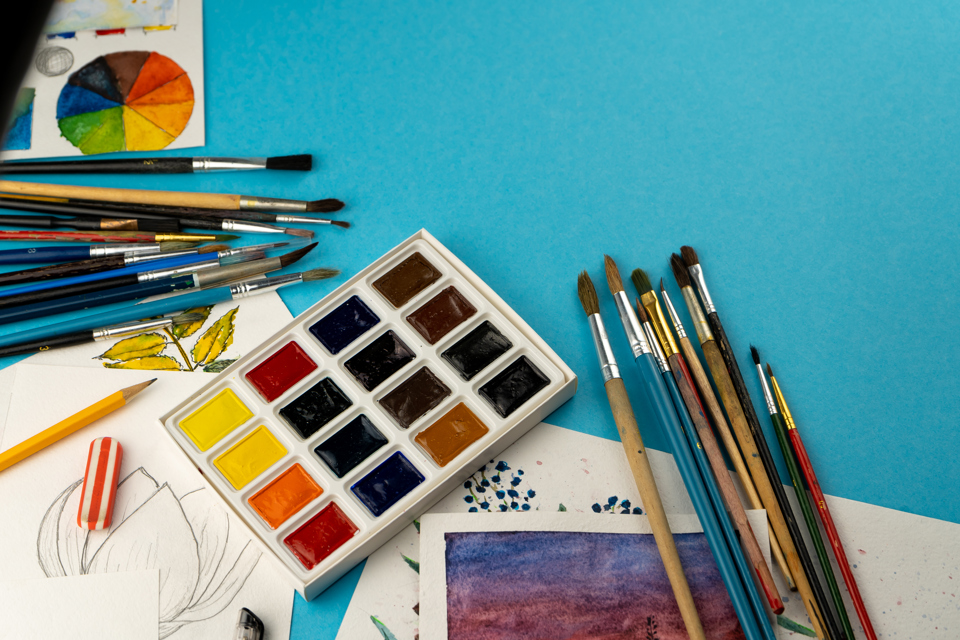 palette-brushes-and-sketches-on-a-blue-backgroun-2026-03-16-02-07-58-utc.jpg