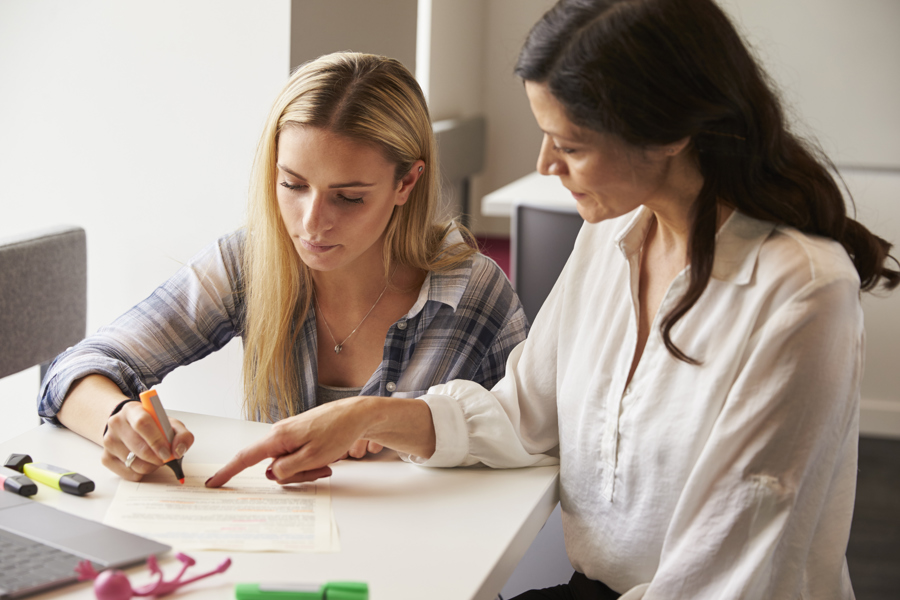 two-women-collaborating-on-documents-at-a-table-2026-01-05-06-30-19-utc.jpg