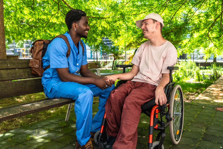 male-caregiver-in-blue-scrubs-smiling-with-man-in-2026-07-09-20-24-06-utc.jpg